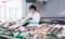 Adult woman selling chilled fish in store