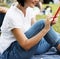 Adult Woman Sitting in The Park Using Mobile Phone