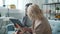 Adult woman and teenage girl working with tablet laughing doing high-five in apartment