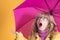 Adult woman with umbrella and surprise