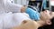 Adult woman undergoes ultrasound of thyroid gland in clinic
