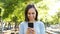 Adult woman using smart phone in a park