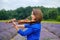 Adult woman violinist playing violin on summer lavender field closeup