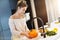 Adult woman washing pumpkin in the kitchen for Halloween