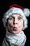 Adult woman with white beard disguised in Santa Claus