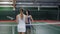 Adult women finished the tennis match, a woman in white sportswear won the competition, the sportswomen hug and shake