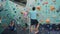 Adults and child enjoying indoor rock-climbing training in gym together
