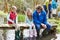 Adults With Children On Bridge At Outdoor Activity Centre