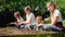 Adults and children digging soil at garden and planting fresh organic vegetable seedlings