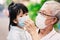 Adults and children wear medical face mask. Grandfather takes care of granddaughter with love and be kind.