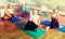 Adults having yoga class in sport club