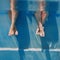 Adults legs underwater in the swimming pool