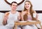 Adults posing with coffee and pastry for breakfast