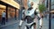 Advanced humanoid robot with glowing eyes in urban settings. Modern white robot android walks along the city street