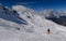 Advanced skiers exploring off piste terrain with breathtaking landscape around.