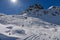 Advanced skiers exploring off piste terrain with breathtaking landscape around.