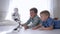 Advanced technologies, modern robot toy is in motion near children on floor in a light room