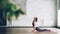 Advanced yoga student is doing combination of balancing and power asanas in modern wellness center. Yoga for health