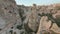 Advancing aerial drone footage Extreme Fast flying between fairy chimneys revealing many cave houses carved into hoodoo