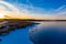 Advancing edge of a freezing lake in winter at sunset