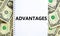 Advantages symbol. Concept word `advantages` on white note. Beautiful background from dollar bills. Business and advantages