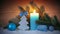 Advent candle and blue decoration with snow. Christmas background.