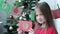 Advent Christmas calendar, portrait of a smiling little girl taking envelope numbered 3, selective focus