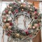 Advent and Christmas Wreath with white willow and orange balls and pearls and red stars