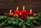 Advent decoration with four red burning candles