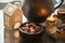 Advent wreath with burning candle and delicious homemade gingerbread cookies in small bowl of black pottery