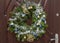 Advent wreath handmade from evergreen spruce branches, decorated with gold, silver and blue Christmas toys, beads and artificial