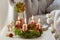 Advent wreath made of moss, cinnamon sticks and rosa canina twigs