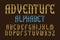 Adventure alphabet. Stylized vintage golden letters font. Isolated english alphabet