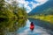 Adventure Caucasian Adult Woman Kayaking in Red Kayak