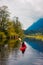 Adventure Caucasian Adult Woman Kayaking in Red Kayak