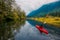 Adventure Caucasian Adult Woman Kayaking in Red Kayak