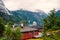 Adventure, discovery, journey. Ship in norwegian fjord on cloudy sky. Ocean liner in village harbor. Travel destination