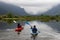 Adventure Friends Kayaking in Kayak surrounded by Canadian Mountain Landscape