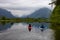 Adventure Friends Kayaking in Kayak surrounded by Canadian Mountain Landscape