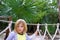 Adventure little girl on jungle park rope bridge