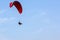 Adventure man active extreme sport pilot flying in sky with paramotor engine glider parachute.