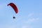 Adventure man active extreme sport pilot flying in sky with paramotor engine glider parachute.
