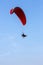 Adventure man active extreme sport pilot flying in sky with paramotor engine glider parachute.