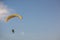 Adventure man active extreme sport pilot flying in sky with paramotor engine glider parachute.