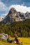 Adventure Man and Dog Trekking Trip Outdoor in Scenic Dolomites Mountains