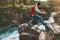 Adventure man jumping on rocks over river canyon
