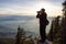 Adventure Photographer taking pictures while Hiking in Canadian Nature