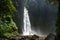 Adventure seeker at beautiful jungle waterfall