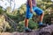 adventure travel. child in sneakers close-up. adventure travel concept. walks along the trunk of a fallen tree