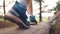 adventure travel. hiker walks on a log legs in boots shoes close-up. adventure travel concept. tourist travels through